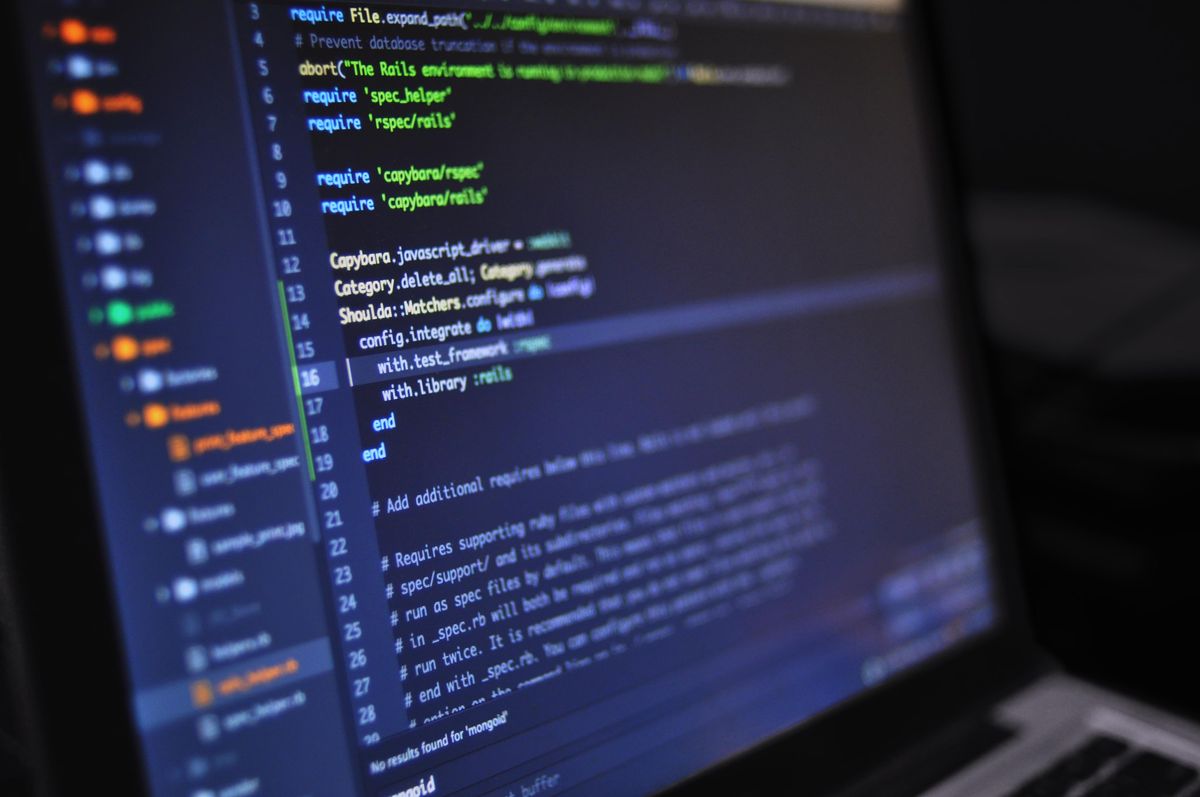 Close-up of programming code on a dark development workspace screen